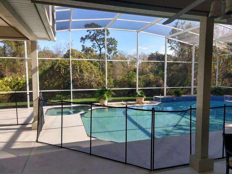 picture showing view from patio of installed pool safety fence around pool in Oviedo home.