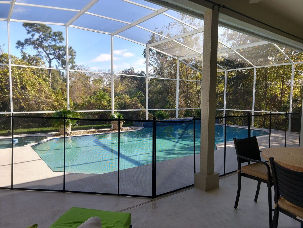 another picture of a properly installed pool fence by premier pool fence at apopka home in an enclosed pool cage area.